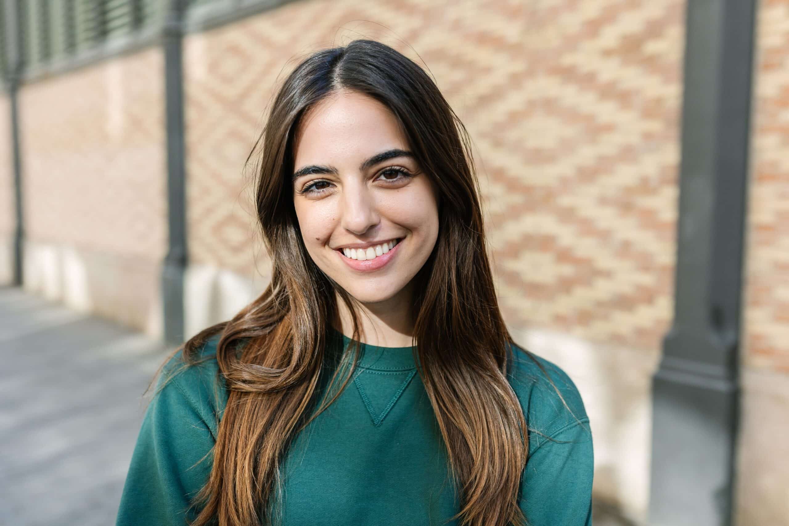 Portrait,Of,Cheerful,Young,Caucasian,Girl,Smiling,At,Camera,Over
